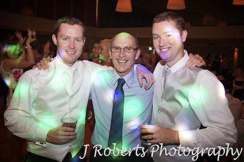 Father and 2 sons on dance floor at wedding reception - wedding photography sydney